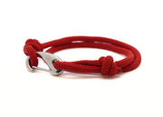 Red braided bracelet with a silver stainless steel clasp